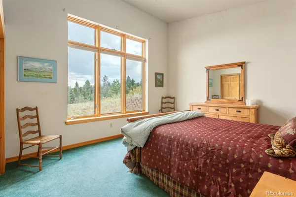 a bedroom with a bed and a cabinet