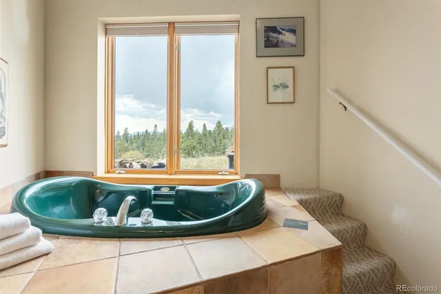 a view of a terrace with furniture and a garden