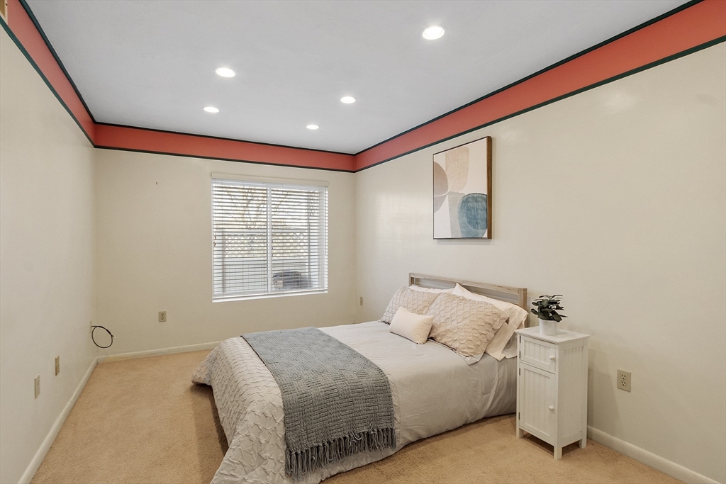 200 Falls Boulevard, Unit D108 Quincy, MA 02169 - Photo 12 of 30 a bedroom with a bed and a window