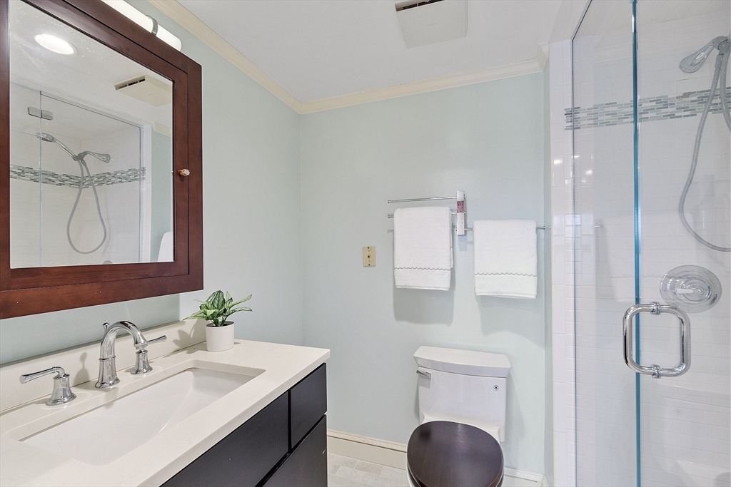 200 Falls Boulevard, Unit D108 Quincy, MA 02169 - Photo 15 of 30 a bathroom with a sink vanity granite toilet and shower