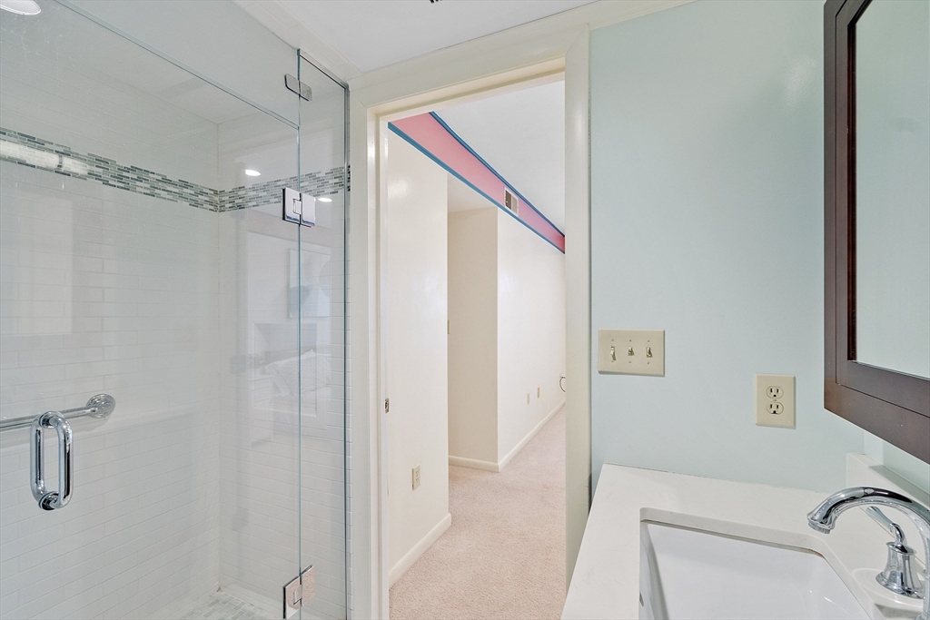 200 Falls Boulevard, Unit D108 Quincy, MA 02169 - Photo 16 of 30 a bathroom with a shower and a sink
