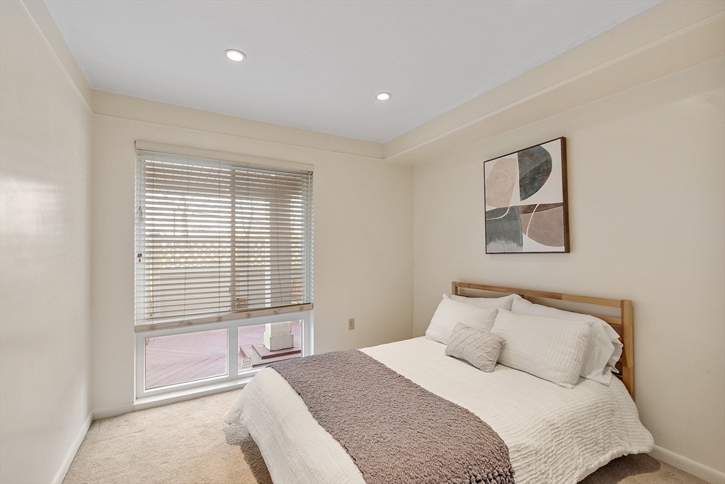 200 Falls Boulevard, Unit D108 Quincy, MA 02169 - Photo 17 of 30 a bedroom with a large bed and a window