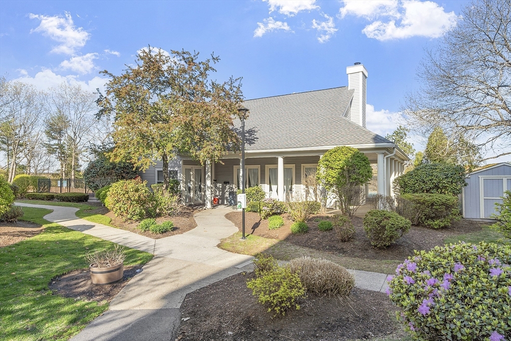 200 Falls Boulevard, Unit D108 Quincy, MA 02169 - Photo 27 of 30 a front view of a house with a yard and outdoor seating