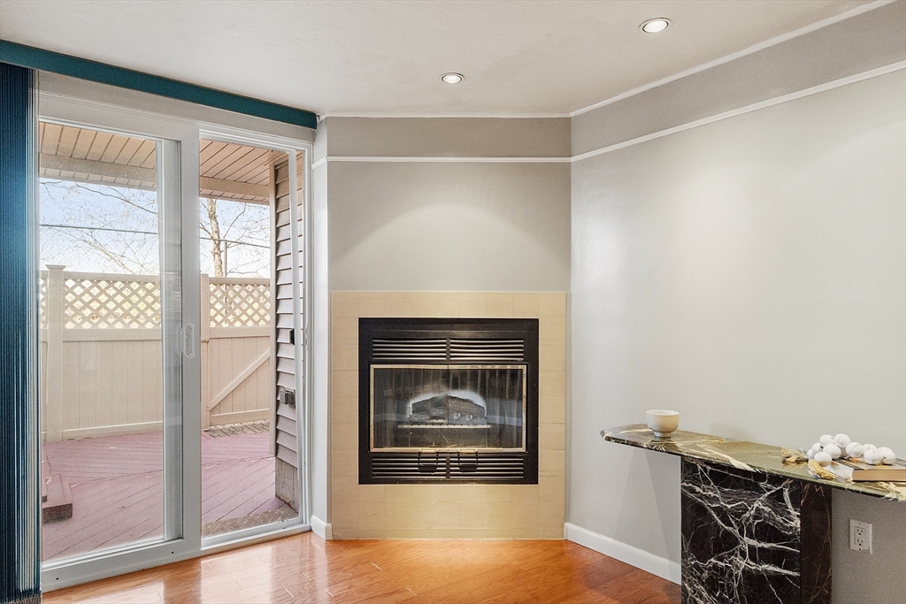 200 Falls Boulevard, Unit D108 Quincy, MA 02169 - Photo 3 of 30 a living room with furniture and a fireplace