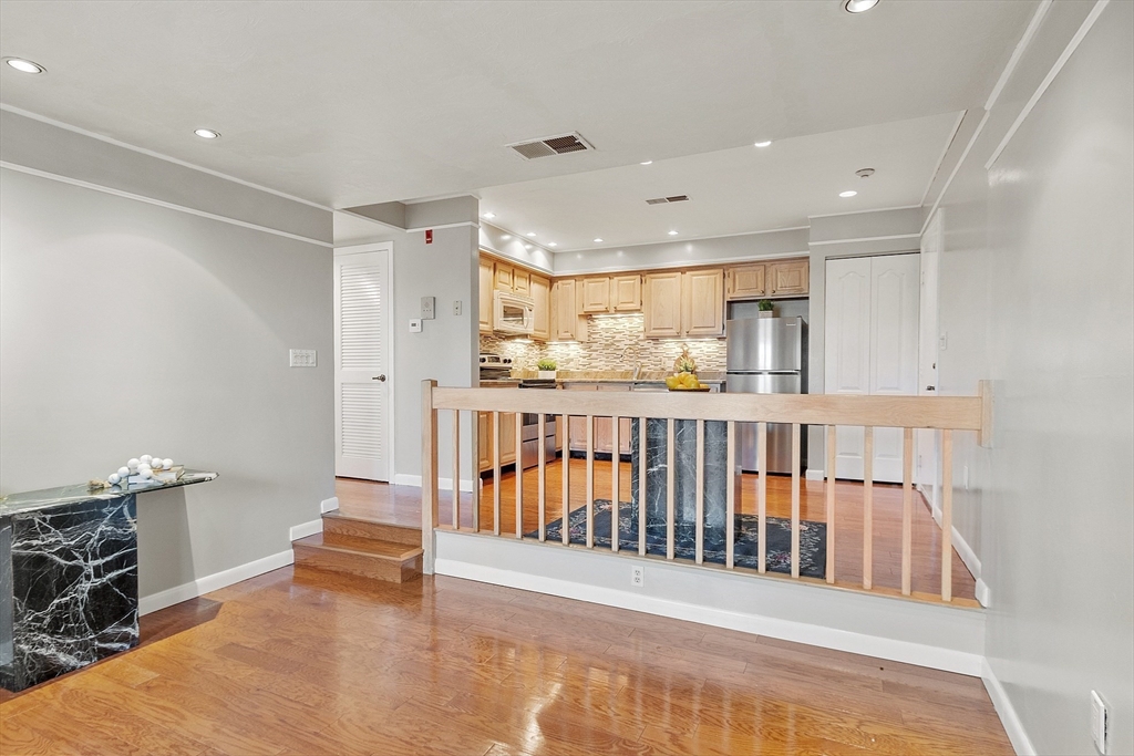 200 Falls Boulevard, Unit D108 Quincy, MA 02169 - Photo 4 of 30 a view of a hallway with kitchen view