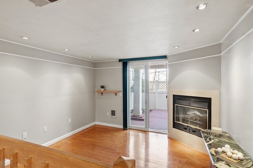 200 Falls Boulevard, Unit D108 Quincy, MA 02169 - Photo 5 of 30 a view of an empty room with a fireplace