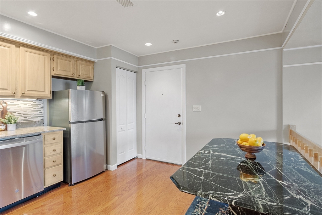200 Falls Boulevard, Unit D108 Quincy, MA 02169 - Photo 10 of 30 a kitchen with stainless steel appliances granite countertop a refrigerator and a stove top oven