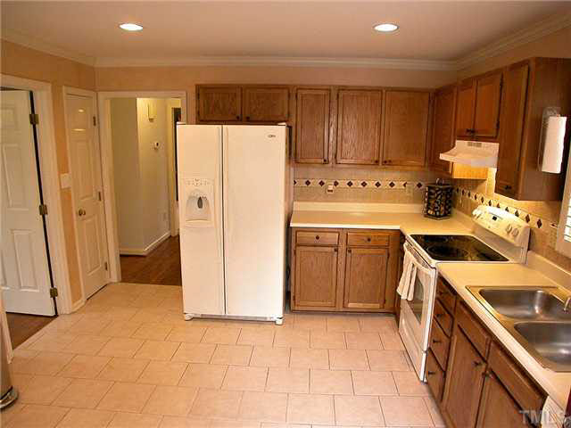 5403 Middleton Road Durham, NC 27713 - Photo 10 of 20 a kitchen with a sink a refrigerator a stove top oven and cabinets