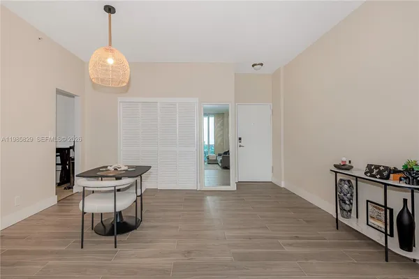 a view of a room with furniture and wooden floor
