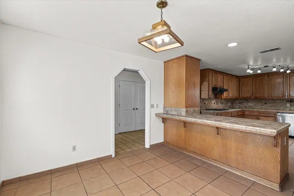 a kitchen with stainless steel appliances granite countertop a sink a stove and a microwave
