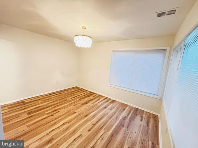 a kitchen with stainless steel appliances a refrigerator and wooden floor