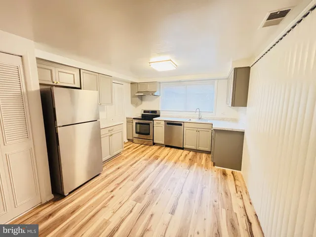 a kitchen with a stove and white cabinets