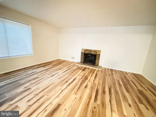 a view of fireplace and wooden floor