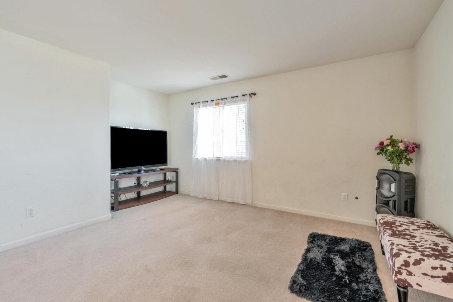 1433 Brahma Street Patterson, CA 95363 - Photo 24 of 43 a bedroom with a bed and a flat screen tv