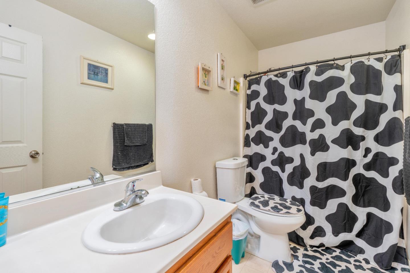 1433 Brahma Street Patterson, CA 95363 - Photo 35 of 43 a bathroom with a sink toilet and a mirror