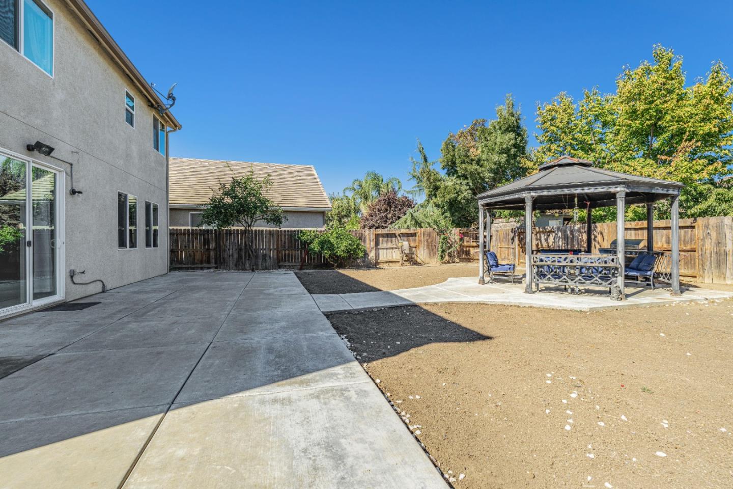1433 Brahma Street Patterson, CA 95363 - Photo 39 of 43 a view of a patio with table and chairs under an umbrella