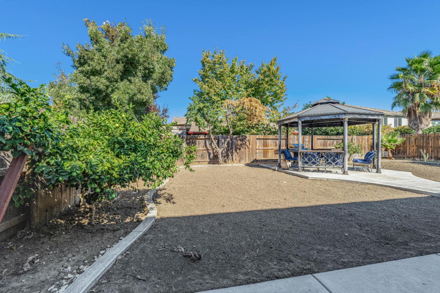 1433 Brahma Street Patterson, CA 95363 - Photo 40 of 43 a view of a table and chairs under an umbrella in the patio