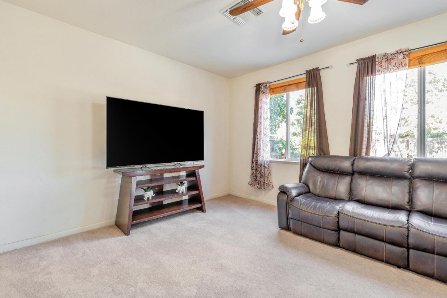 1433 Brahma Street Patterson, CA 95363 - Photo 6 of 43 a living room with furniture and a flat screen tv