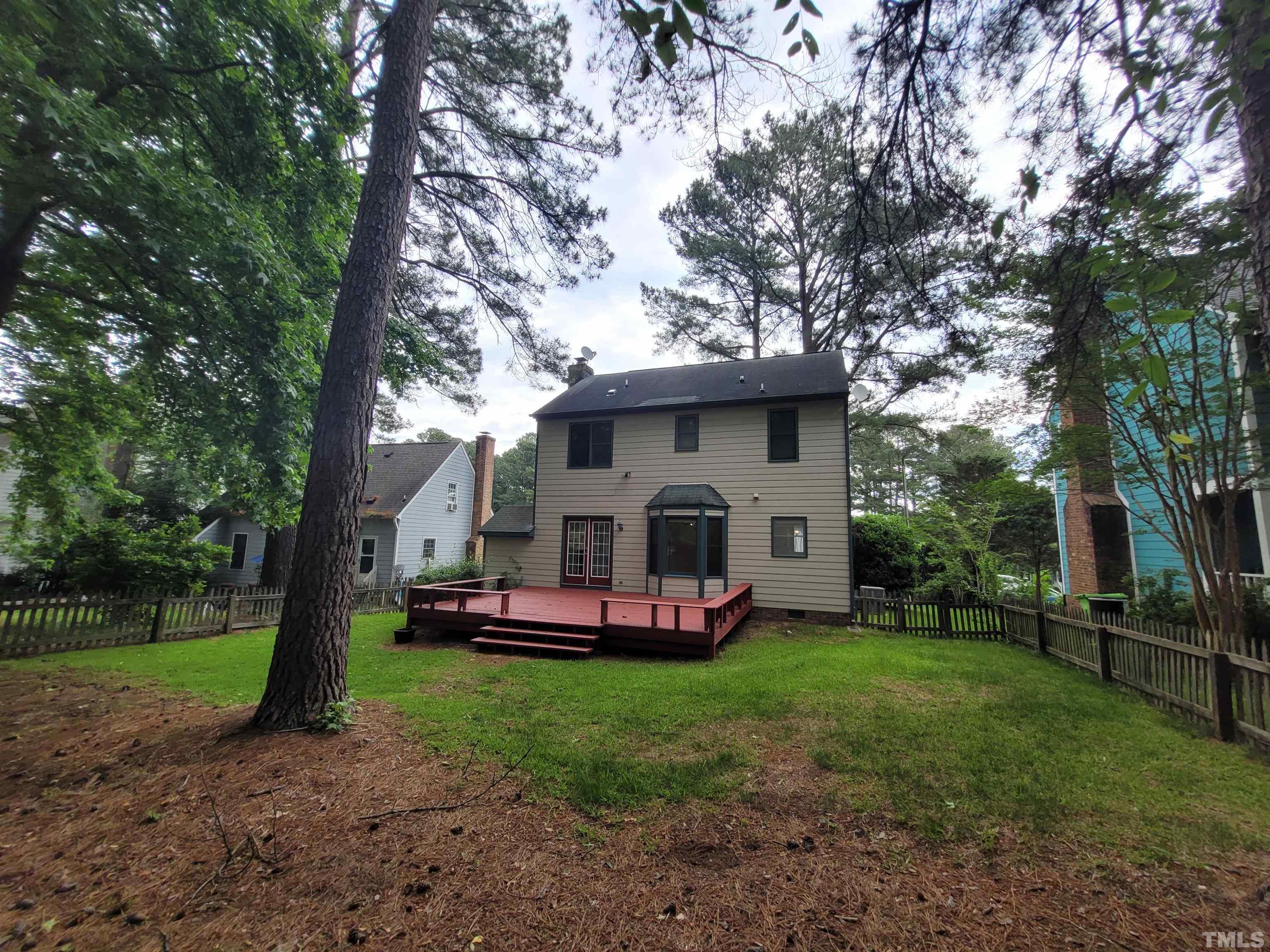 4836 Draper Road Raleigh, NC 27616 - Photo 16 of 16 a front view of a house with a garden and trees