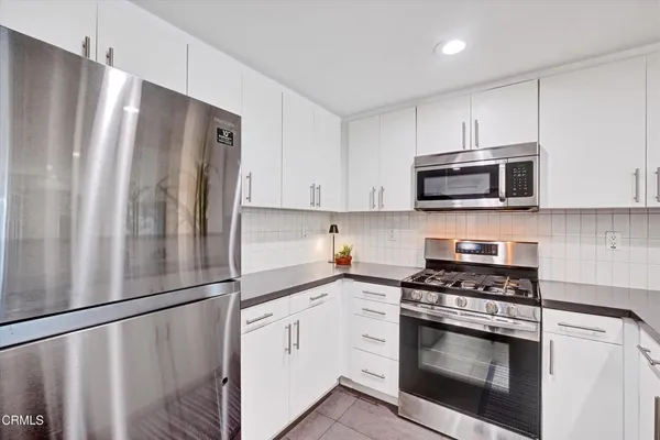 a kitchen with a sink a counter and cabinets