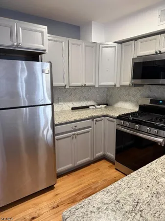 a kitchen with a refrigerator stove and microwave