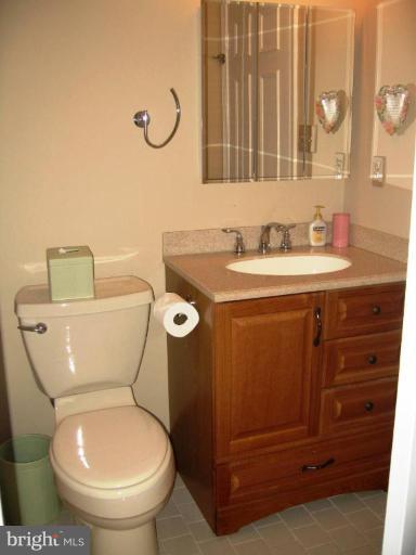 6278 Rathlin Drive Springfield, VA 22152 - Photo 2 of 25 a bathroom with a toilet a sink and a mirror
