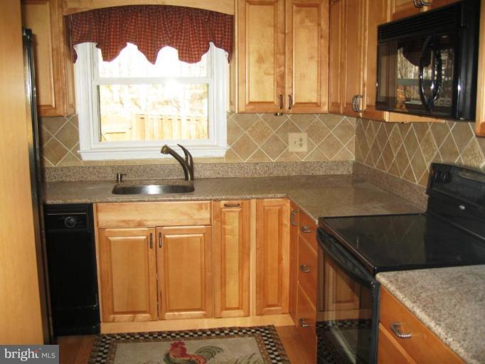 6278 Rathlin Drive Springfield, VA 22152 - Photo 13 of 25 a bathroom with a granite countertop sink and a window