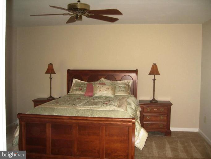 6278 Rathlin Drive Springfield, VA 22152 - Photo 17 of 25 a bed sitting in a bedroom next to a window