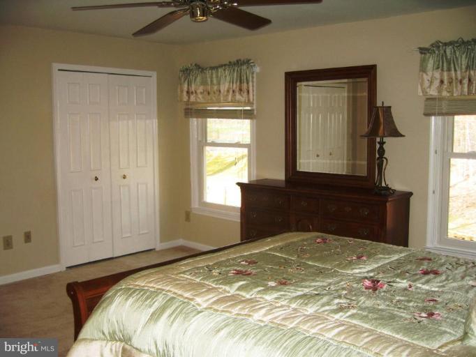 6278 Rathlin Drive Springfield, VA 22152 - Photo 19 of 25 a bedroom with a bed and a window