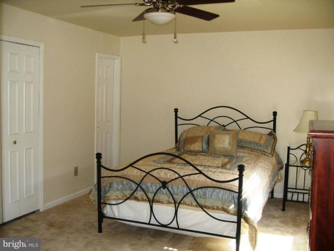 6278 Rathlin Drive Springfield, VA 22152 - Photo 20 of 25 a bedroom with a bed and a dresser