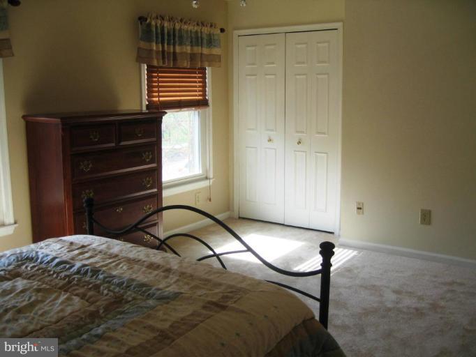 6278 Rathlin Drive Springfield, VA 22152 - Photo 21 of 25 a bedroom with a bed and a dresser