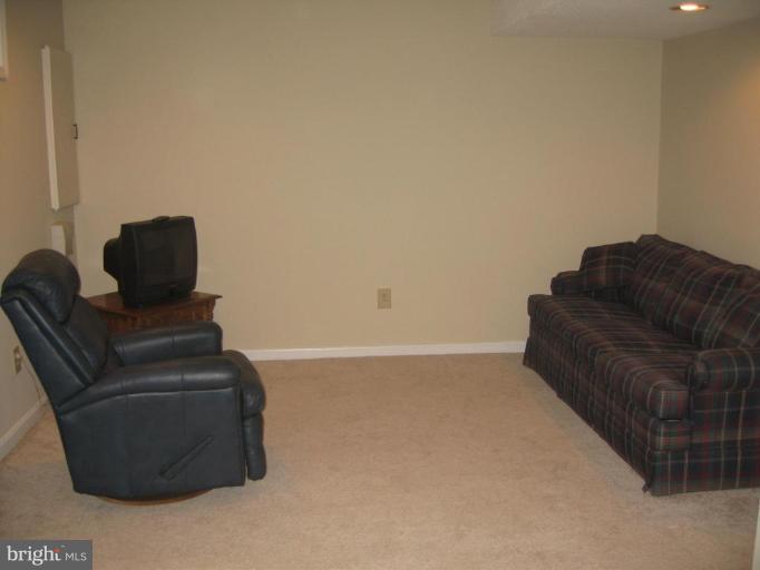 6278 Rathlin Drive Springfield, VA 22152 - Photo 23 of 25 a living room with furniture and a couch