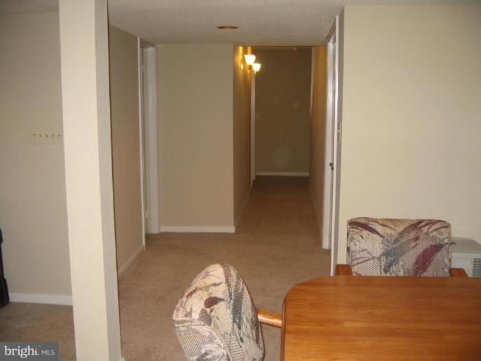 6278 Rathlin Drive Springfield, VA 22152 - Photo 25 of 25 a bedroom with a bed and a mirror