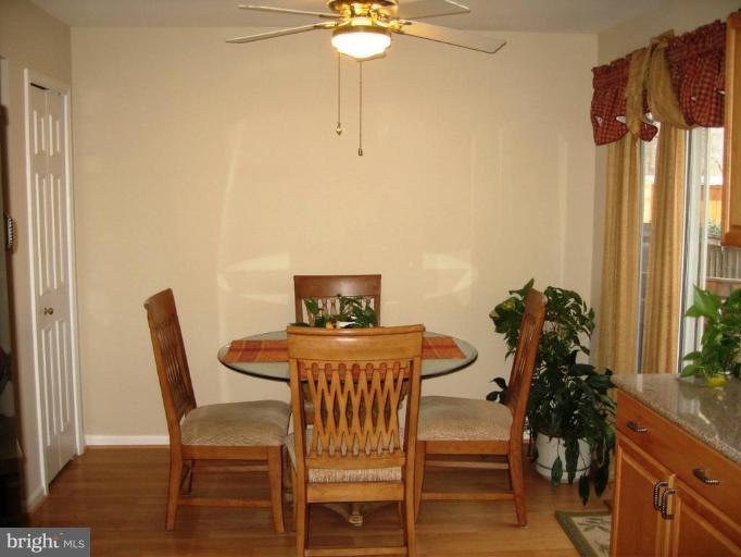 6278 Rathlin Drive Springfield, VA 22152 - Photo 4 of 25 a view of a dining room with furniture and a potted plant