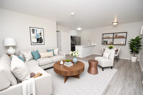 a living room with furniture and wooden floor