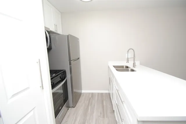 a room with a sink and wooden floor