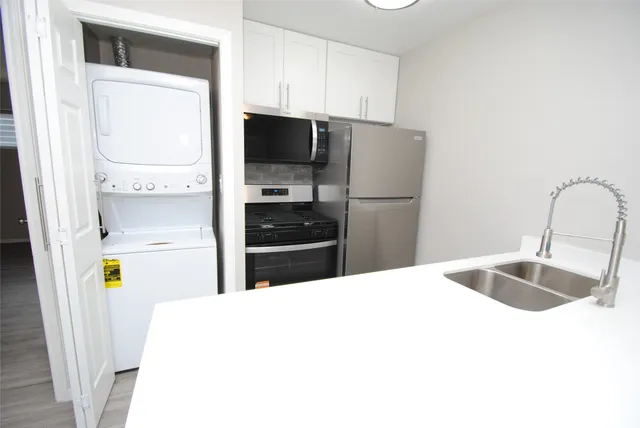 a kitchen with a sink appliances and cabinets