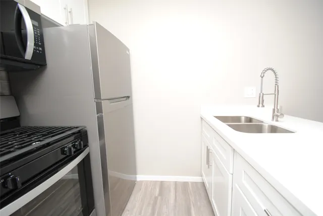 a kitchen with a sink and a refrigerator