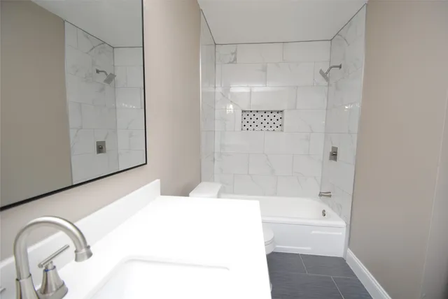 a bathroom with a bathtub and a shower
