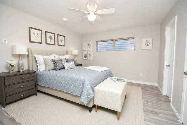 a bedroom with a bed and a chandelier