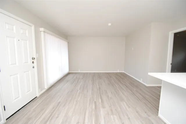 a view of a room with wooden floor