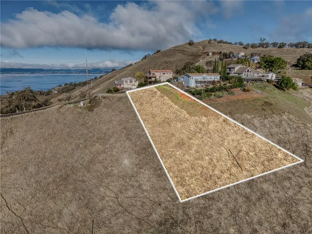 a view of a yard with wooden fence