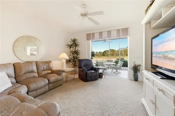 a living room with furniture fireplace and flat screen tv