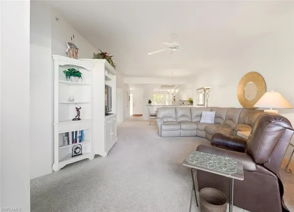 a living room with furniture and a large mirror