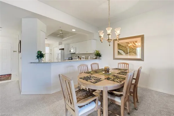 a view of a dining room with furniture and chandelier