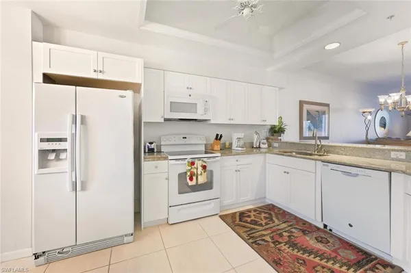 a kitchen with stainless steel appliances a refrigerator sink and cabinets