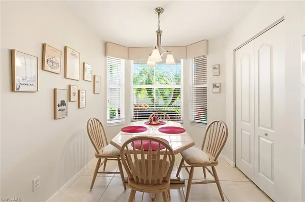 a dining room with furniture and window