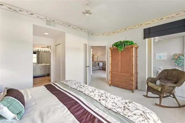 a bedroom with furniture and a rug