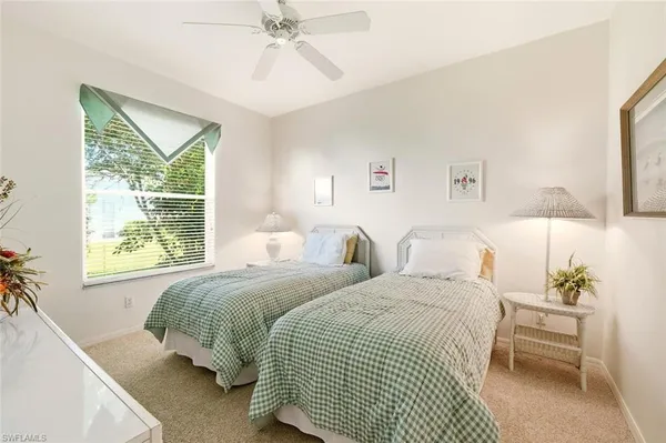 a bedroom with two beds and a window