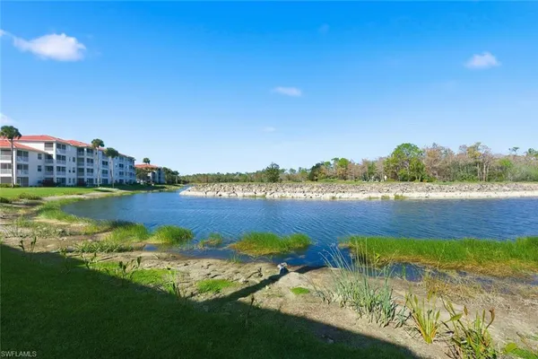 a view of a lake with houses in the back